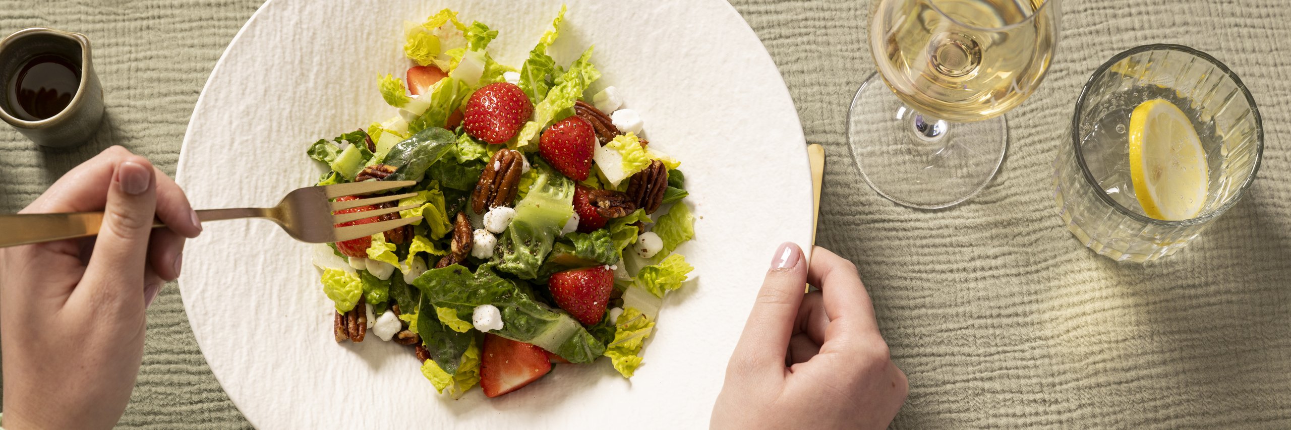 Salade met aardbeien en een glas wijn