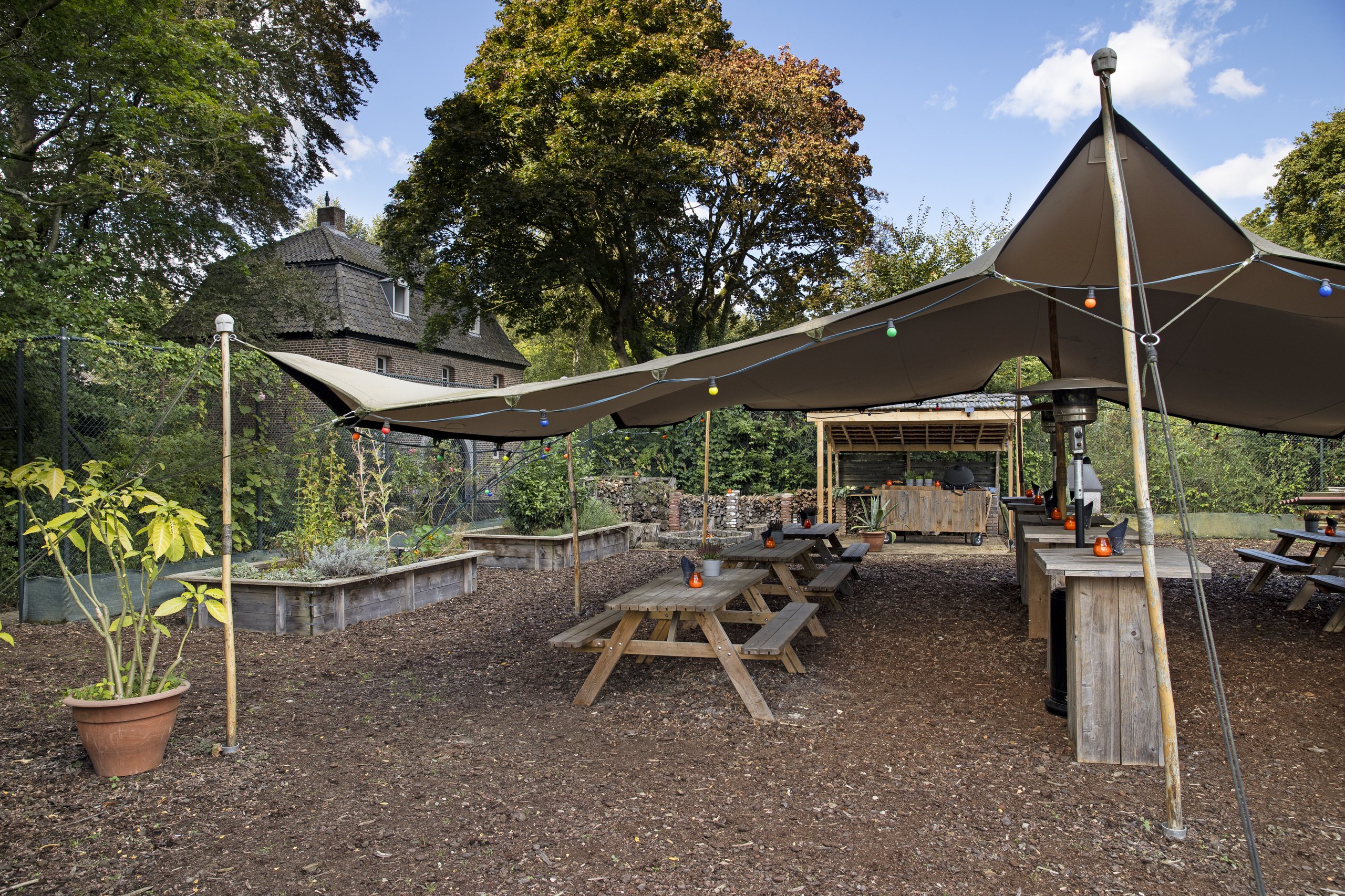 Zicht vanaf de tent in de kruidentuin met op de achtergrond Château Holtmühle