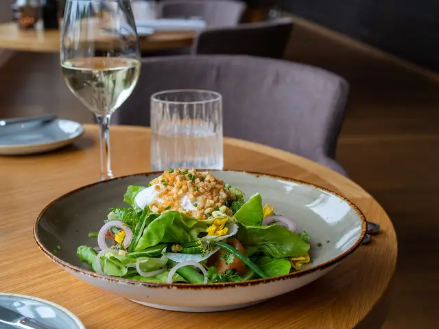 A green salad and a glass of white wine